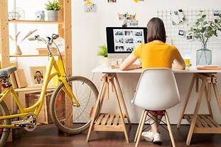 image of student sitting at a desk in an apartment